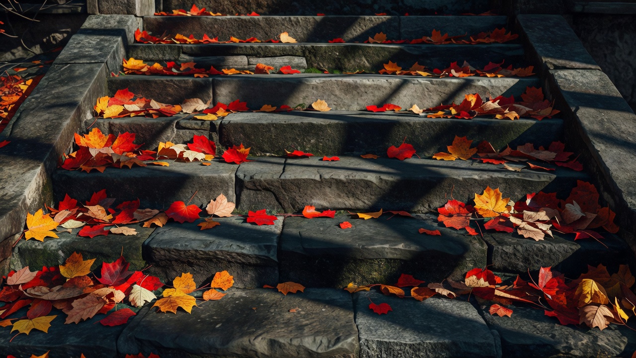 Fallen autumn leaves scattered across shadowed stone steps